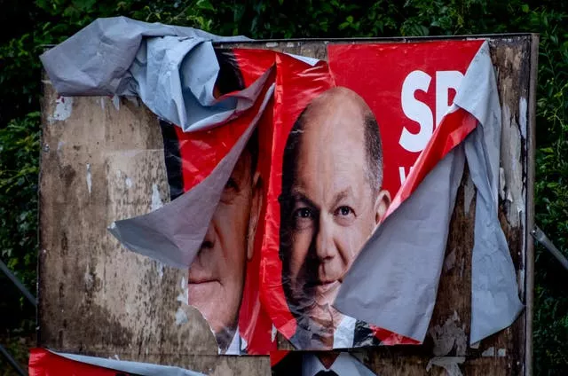 A damaged poster of Olaf Scholz