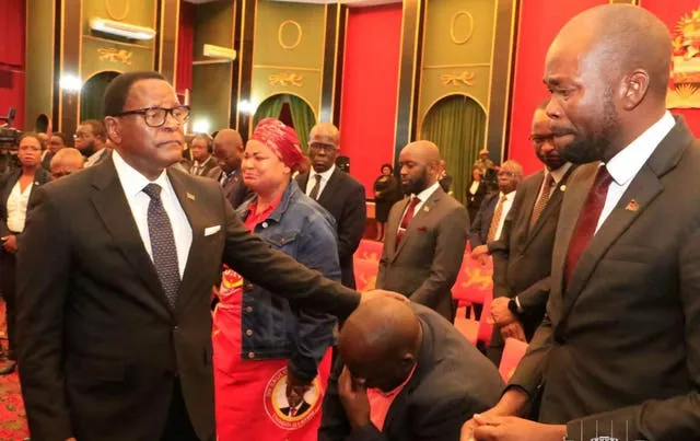 Malawian President Lazarus Chakwera, left, greets people in Lilongwe, where he made an announcement that the vice president and nine others had been killed in a plane crash