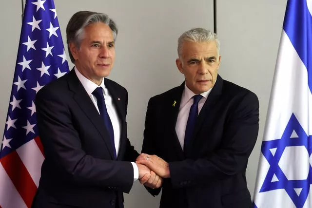 US Secretary of State Antony Blinken, left, shakes hands with Israeli opposition leader Yair Lapid during a meeting in Tel Aviv