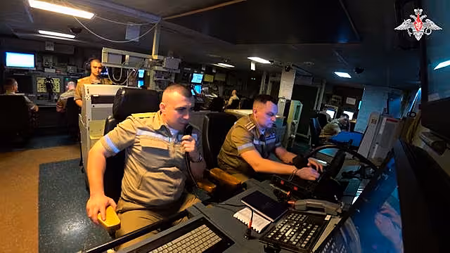Navy personnel taking part in drills on board a Russian frigate