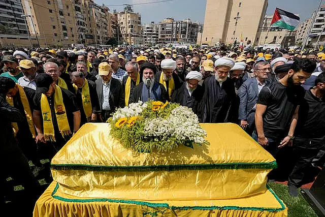 People pray over the coffin of senior Hezbollah commander Taleb Sami Abdullah who was killed on Tuesday by an Israeli strike in south Lebanon