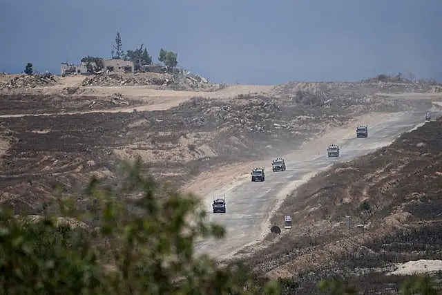 A column of Israeli military vehicles leave the Gaza Strip 