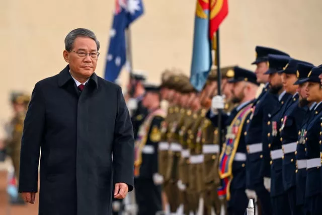 Chinese Premier Li Qiang inspects a guard of honor outside Parliament House in Canberra, Australia, Monday