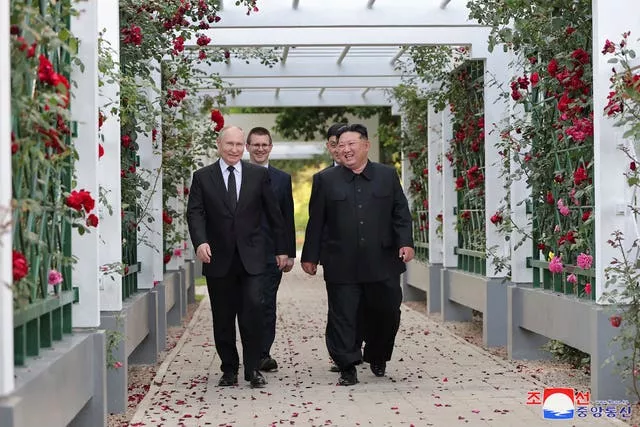 North Korean leader Kim Jong Un and Russia’s President Vladimir Putin walking through a garden