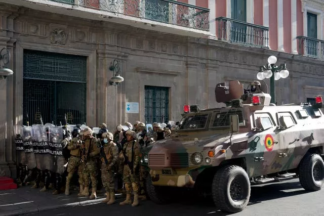 Un véhicule blindé et des policiers militaires devant le palais du gouvernement à La Paz