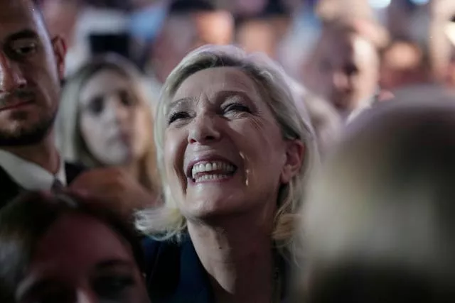 French far right leader Marine Le Pen reacts as she meets supporters and journalists after the release of projections based on the actual vote count in select constituencies 