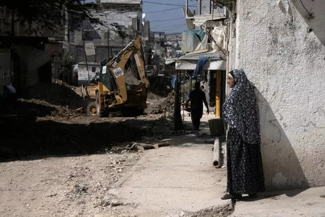 A Palestinian woman watches an operation by the Israeli military in Tulkarem refugee camp in the West Bank