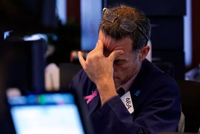 Trader Gregory Rowe works on the floor of the New York Stock Exchange on Monday, August 5 