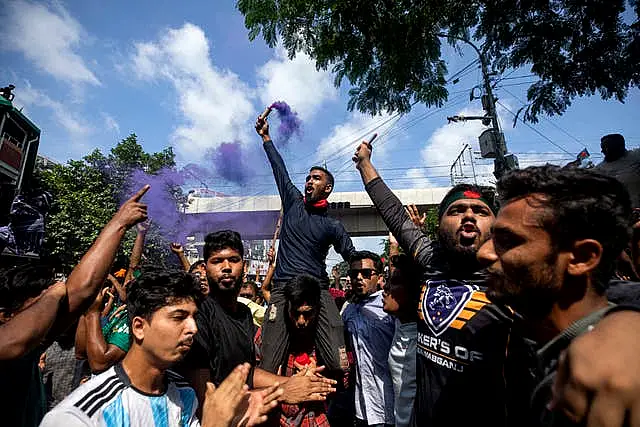 Protesters carrying flares celebrate in the streets