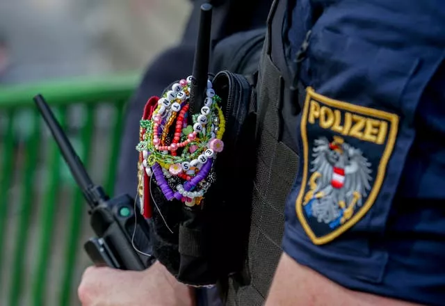 An Austrian police officer is decorated with bracelets 