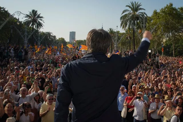 Catalan independence leader Carles Puigdemont addresses supporters near the Catalan parliament in Barcelona on Thursday