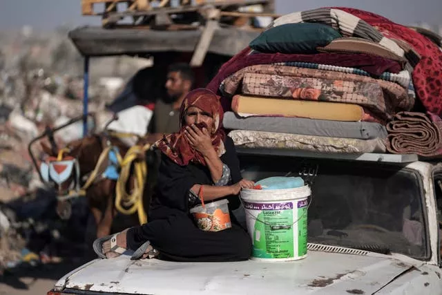 A Palestinian woman flees the Khan Younis area of the Gaza Strip 