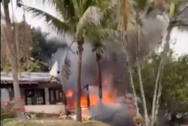 This frame grab from video shows fire coming from a plane that crashed by a home in Vinhedo, Sao Paulo state