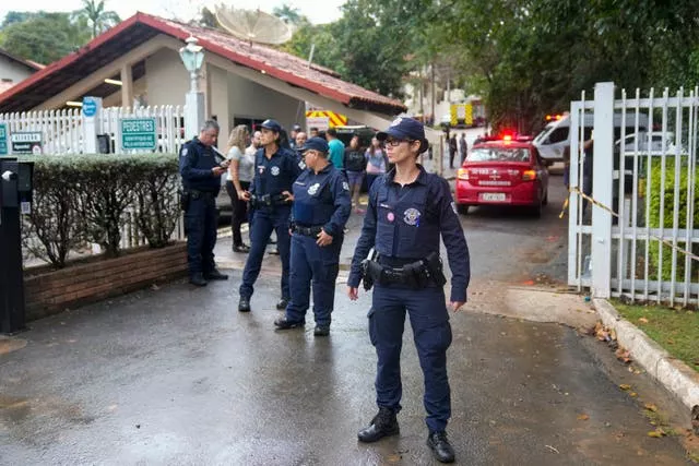 Police guard the gated community where a plane crashed in Vinhedo, Sao Paulo state, Brazil