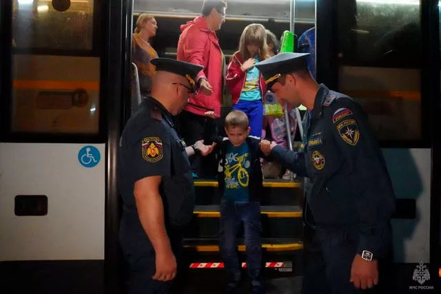 People evacuated from fighting between Russian and Ukrainian forces in the Kursk region arrive to a temporary residence centre in Moscow