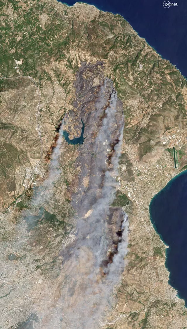 A satellite image showing smoke rising from wildfires in East Attica, some 22 miles north of Athens