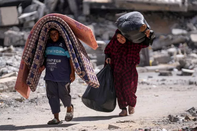 Palestinians displaced by the Israeli air and ground offensive on the Gaza Strip flee from Hamad City