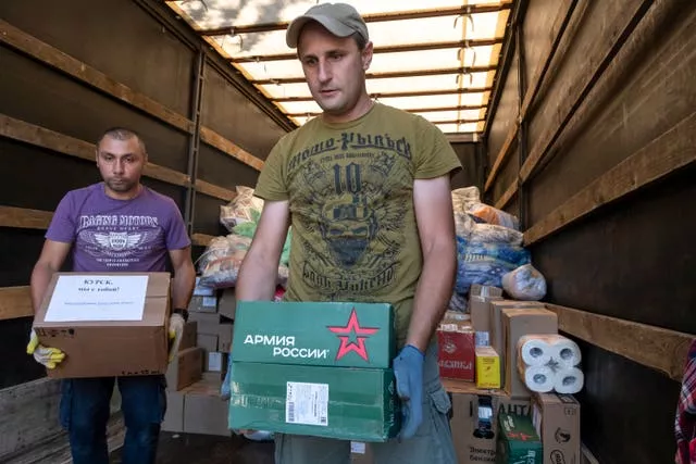 Volunteers unload humanitarian aid to people evacuated from fighting between Russian and Ukrainian forces in the Kursk region, at a temporary residence centre in Kursk, Russia 