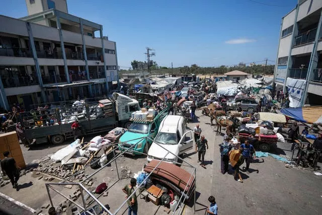 Crowds of people flee with their belongings