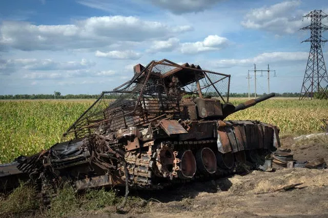 A destroyed Russian tank on a roadside near the town of Sudzha in the Kursk region