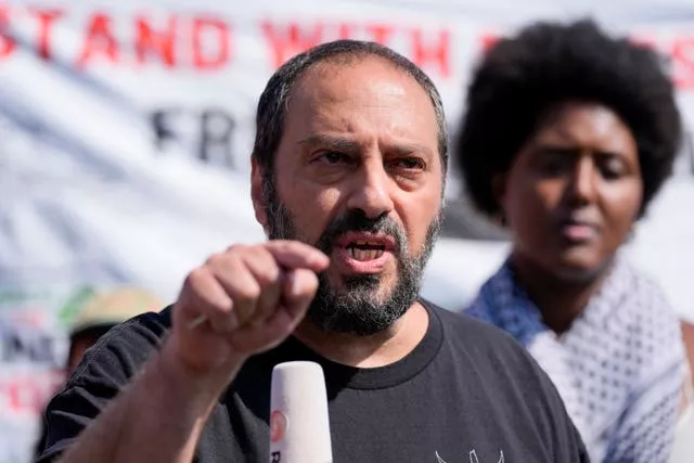 Hatem Abudayyeh, of the US Palestinian Community Network, speaks prior to a march to the Democratic National Convention