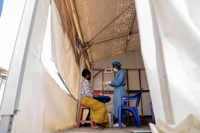 A health worker attends to an mpox patient 