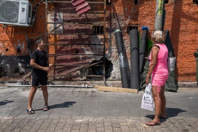 People look at the damage after a bomb explosion in Tel Aviv, Israel 