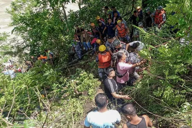 Rescuers above a a river near Abukhaireni town