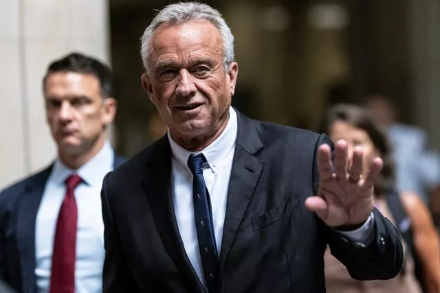 Robert F Kennedy Jr waves to the media outside the Nassau County Supreme Court in Mineola, New York