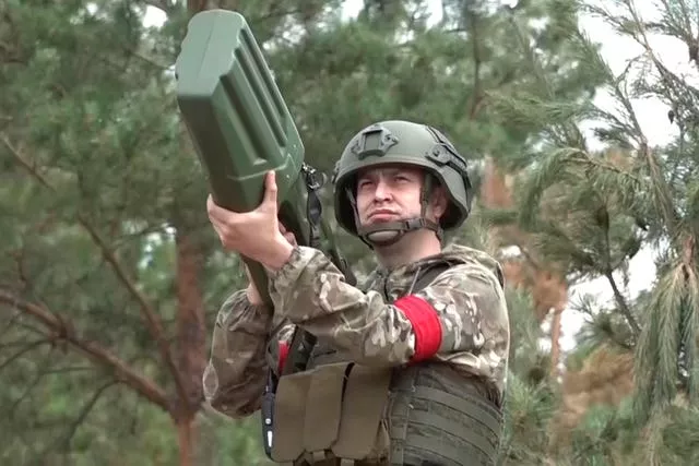 A Russian serviceman aims an anti-drone gun in an undisclosed location