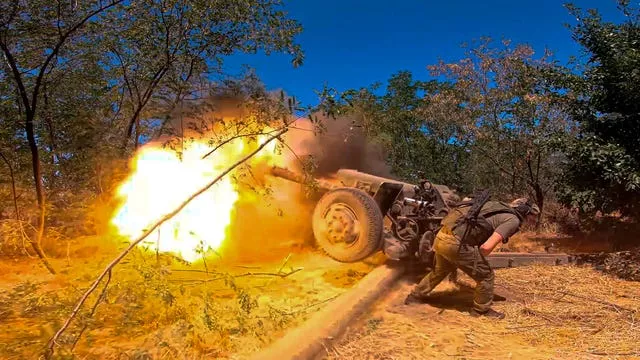 A Russian soldier fires from a D-30 howitzer towards Ukrainian positions in an undisclosed location in Ukraine