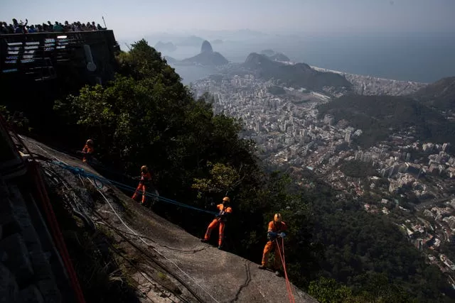 APTOPIX Brazil Trash Collector Climbers