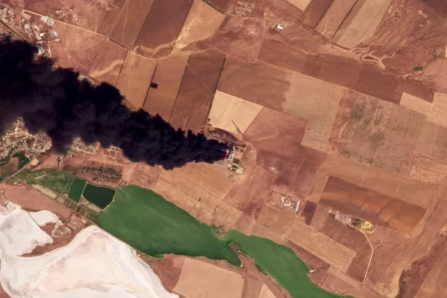 This satellite photo from Planet Labs PBC shows a fire at an oil depot earlier hit by a Ukrainian drone attack near Proletarsk