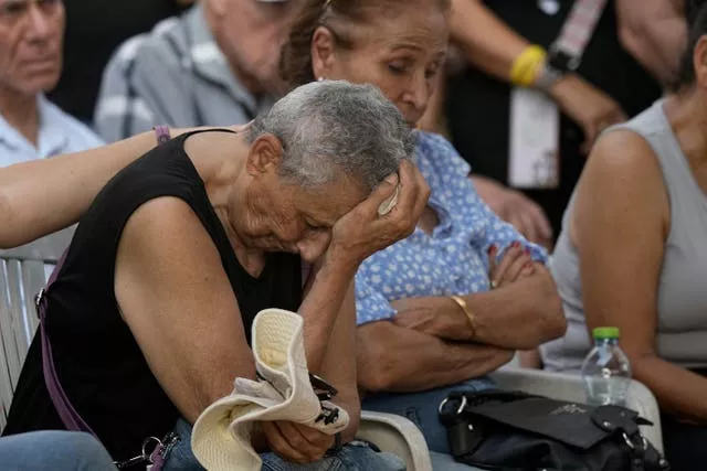 Tami Metzger mourns during the funeral of her husband Yoram Metzger at a cemetery of the kibbutz Nir Oz, southern Israel