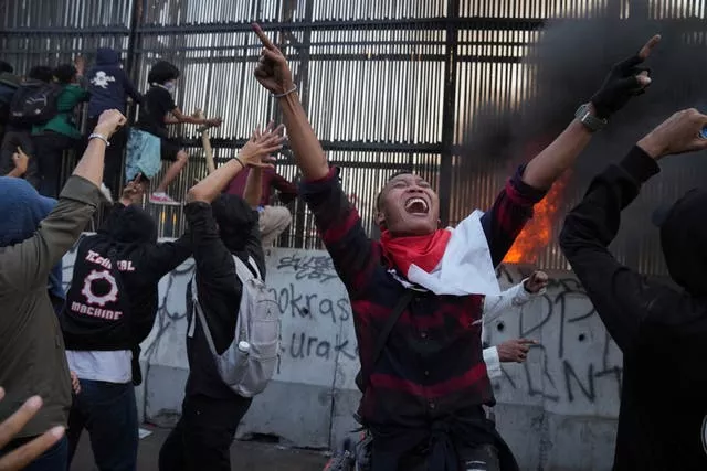 Protesters attempt to storm Indonesia’s parliament during a protest against controversial changes to election laws