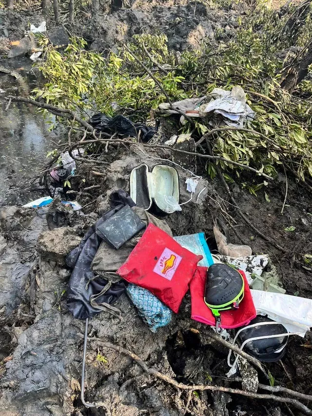 Passengers’ belongings are seen at the crash site in Chachoengsao province Thailand