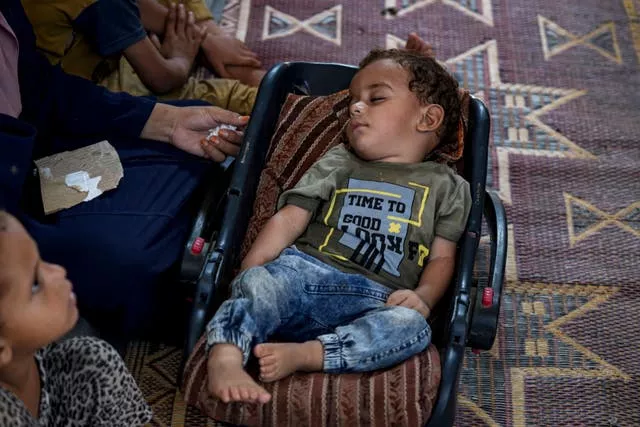 Displaced infant Abdel-Rahman Abu El-Jedian, who suffers from polio, sleeps at a makeshift tent camp in Deir al-Balah, central Gaza Strip