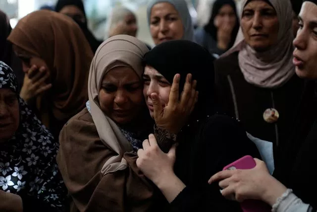 Mourners cry during the funeral of five Palestinians who were killed by an Israeli military air strike in the northern occupied West Bank