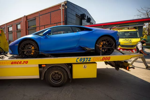 A blue car on a low loader