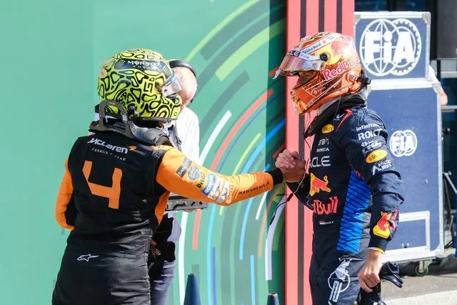 Red Bull driver Max Verstappen of the Netherlands, right, congratulates McLaren driver Lando Norris of Britain on his victory in the Formula One Dutch Grand Prix