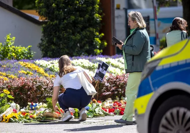 Flowers and candles are placed in Solingen near the scene of Friday’s deadly attack