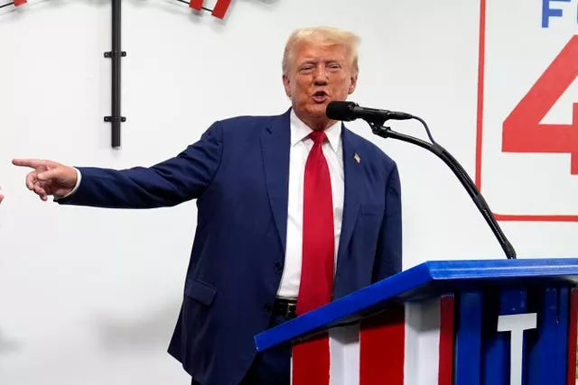 Republican presidential nominee former President Donald Trump speaks during a stop at a campaign office in Roseville, Michigan 