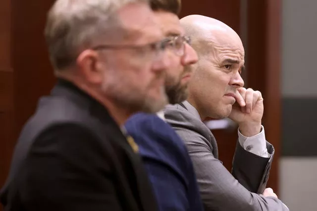 Robert Telles, right, listens to closing arguments during his murder trial