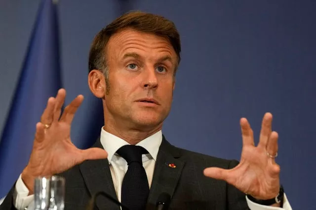 French President Emmanuel Macron gestures during a press conference in Belgrade, Serbia