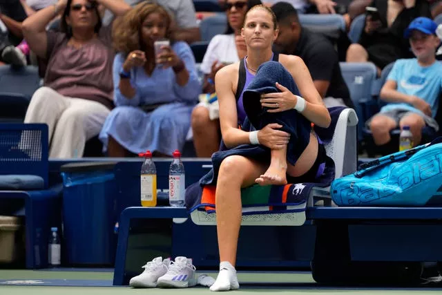 Karolina Pliskova holds her ankle 