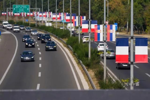 French and Serbian flags fly on lampposts on a highway in Belgrade, Serbia, ahead of French President Emmanuel Macron two-day state visit to Serbia