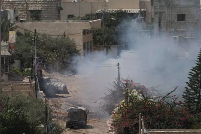 Smoke rises after a blast in a group of houses