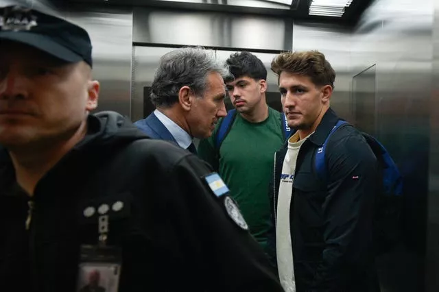 Oscar Jegou, right, and Hugo Auradou, second from right, stand next to their lawyer Rafael Cuneo Libarona at the airport in Buenos Aires