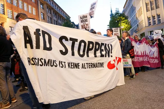 Participants in a demonstration against the right hold a banner with the slogan 'Stop AfD! Racism is not an alternative' in Hamburg