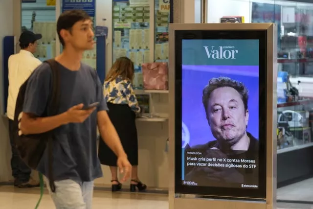 A photo of Elon Musk on an advertising board